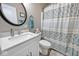 Modern bathroom with a single sink vanity and a blue decorative shower curtain at 217 N Liberty Blvd, Mooresville, IN 46158