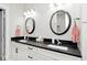 Bathroom with granite countertops, dual sinks and round mirrors, combining style and functionality at 217 N Liberty Blvd, Mooresville, IN 46158