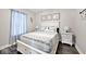 Beautiful bedroom with a queen bed, decorative pillows, and a wooden floor at 217 N Liberty Blvd, Mooresville, IN 46158