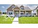 Charming home featuring a welcoming front porch, complemented by well-maintained landscaping and an inviting exterior at 217 N Liberty Blvd, Mooresville, IN 46158