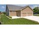 Attached garage with a spacious driveway and a well manicured lawn at 217 N Liberty Blvd, Mooresville, IN 46158
