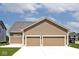 A spacious two car attached garage with brown doors at 217 N Liberty Blvd, Mooresville, IN 46158