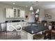 Stylish kitchen island with seating, black countertops and built-in beverage refrigerator at 217 N Liberty Blvd, Mooresville, IN 46158