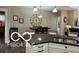 Open-concept kitchen featuring granite countertops, island sink and breakfast bar at 217 N Liberty Blvd, Mooresville, IN 46158