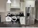 Kitchen with stainless steel appliances, granite countertops, and ample storage space at 217 N Liberty Blvd, Mooresville, IN 46158