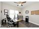 Home office featuring an adjustable desk, office chair, and natural light from a large window at 217 N Liberty Blvd, Mooresville, IN 46158