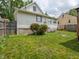 A view of the backyard with grass and a home featuring white siding and dark window trim at 2528 S Pennsylvania St, Indianapolis, IN 46225