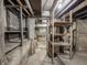 View of an unfinished basement with exposed supports and concrete floor at 2528 S Pennsylvania St, Indianapolis, IN 46225