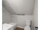 A bathroom with decorative tile, and a modern toilet and towel rack at 2528 S Pennsylvania St, Indianapolis, IN 46225