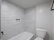 Well-lit bathroom featuring neutral tile and modern toilet at 2528 S Pennsylvania St, Indianapolis, IN 46225