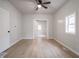Bright, open bedroom features light wood floors, a ceiling fan, and a window for natural light at 2528 S Pennsylvania St, Indianapolis, IN 46225
