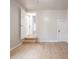 Bedroom with light wood floors, neutral paint, and stairs to a side entrance at 2528 S Pennsylvania St, Indianapolis, IN 46225