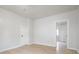 Neutral-painted bedroom features light wood floors and a door to another room at 2528 S Pennsylvania St, Indianapolis, IN 46225