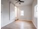This bedroom features new floors, neutral paint, a barn door, a window, and modern lighting at 2528 S Pennsylvania St, Indianapolis, IN 46225