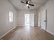 This bedroom features new floors, neutral paint, a window, and decorative doors to other rooms at 2528 S Pennsylvania St, Indianapolis, IN 46225