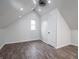A bedroom with hardwood floors, a window, and an open ceiling space is awash with natural light at 2528 S Pennsylvania St, Indianapolis, IN 46225