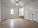 Bright bedroom with light wood floors, stairs to a side entrance, and a new window at 2528 S Pennsylvania St, Indianapolis, IN 46225