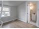 Comfortable bedroom featuring a window for natural light and wood-look laminate flooring at 2528 S Pennsylvania St, Indianapolis, IN 46225