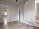 This bedroom features new floors, neutral paint, a barn door, an accompanying door, and modern lighting at 2528 S Pennsylvania St, Indianapolis, IN 46225