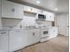Updated kitchen featuring white cabinets, marble countertops, and stainless steel appliances at 2528 S Pennsylvania St, Indianapolis, IN 46225