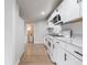 Modern, bright kitchen with white cabinets, marble countertops, and stainless-steel appliances at 2528 S Pennsylvania St, Indianapolis, IN 46225