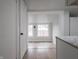 Bright kitchen featuring wood floors, white cabinets, and stainless-steel appliances at 2528 S Pennsylvania St, Indianapolis, IN 46225