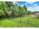 Picture of the back yard and fence line with green grass and mature trees offers privacy and outdoor enjoyment at 2623 Senators Way, Indianapolis, IN 46217