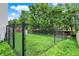 Spacious, fenced backyard with lush green grass and mature trees offers privacy and outdoor enjoyment at 2623 Senators Way, Indianapolis, IN 46217