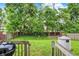 View of a well-maintained backyard with mature trees, shed, and privacy fencing at 2623 Senators Way, Indianapolis, IN 46217