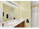 Bright bathroom features double sink vanity with dark wood cabinets and large mirror with modern lighting fixture at 2623 Senators Way, Indianapolis, IN 46217