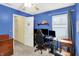 Bedroom with blue walls, ceiling fan, window, and adjacent bathroom provides a comfortable and private space at 2623 Senators Way, Indianapolis, IN 46217