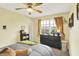 Bedroom features a ceiling fan, neutral walls, and large window with black dresser at 2623 Senators Way, Indianapolis, IN 46217