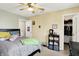 Cozy bedroom with neutral walls, ceiling fan, and large bed offers a relaxing retreat with hall access at 2623 Senators Way, Indianapolis, IN 46217