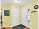 Bright foyer featuring wood floors, a coat closet, and neutral-colored walls at 2623 Senators Way, Indianapolis, IN 46217