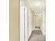 Hallway featuring neutral carpet, white trim, and multiple doors leading to different rooms at 2623 Senators Way, Indianapolis, IN 46217