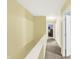 Upstairs hallway with neutral carpet, white trim, and access to various rooms in the home at 2623 Senators Way, Indianapolis, IN 46217