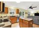 Bright kitchen featuring wood cabinets, stainless steel appliances, and a view to the backyard at 2623 Senators Way, Indianapolis, IN 46217