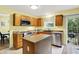 Bright kitchen featuring wood cabinets, stainless steel appliances, and a sliding glass door to the backyard at 2623 Senators Way, Indianapolis, IN 46217