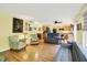 Open-concept living room with hardwood floors and easy access to an adjoining kitchen and dining area at 2623 Senators Way, Indianapolis, IN 46217