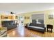 Bright living room with hardwood floors, modern furnishings, and sliding glass doors to the outside at 2623 Senators Way, Indianapolis, IN 46217