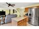 Open-concept kitchen flows into a living area, featuring stainless steel appliances and a comfortable sofa at 2623 Senators Way, Indianapolis, IN 46217