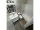 Full bathroom with updated tub and vanity with modern fixtures and vinyl flooring at 2717 N Rural St, Indianapolis, IN 46218