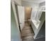 Updated bathroom features vanity, hardware, and lighting with wood-look flooring at 2717 N Rural St, Indianapolis, IN 46218