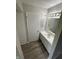 Bathroom features updated vanity, hardware, and lighting with wood-look flooring at 2717 N Rural St, Indianapolis, IN 46218