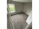 This bedroom features a large window that allows in natural light and neutral carpet at 2717 N Rural St, Indianapolis, IN 46218