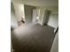 Bedroom with neutral walls and carpet, closet with shelving, and bathroom located through door at 2717 N Rural St, Indianapolis, IN 46218
