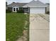 Charming single-story home with a two-car garage and tidy front yard featuring green bushes at 2717 N Rural St, Indianapolis, IN 46218