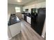 Modern kitchen featuring white cabinets, black countertops, and stainless-steel appliances at 2717 N Rural St, Indianapolis, IN 46218