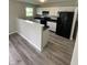 Modern kitchen with white cabinets, black countertops, and stainless-steel appliances at 2717 N Rural St, Indianapolis, IN 46218