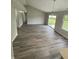 Spacious living room with wood floors, bright lighting, and access to backyard through sliding door at 2717 N Rural St, Indianapolis, IN 46218